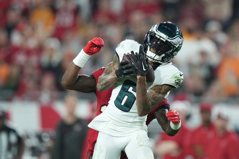 FILE - Philadelphia Eagles wide receiver DeVonta Smith (6) catches a deep pass as Tampa Bay Buccaneers cornerback Jamel Dean (35) defends during an NFL wild-card playoff football game, Monday, Jan. 15, 2024, in Tampa, Fla. The Philadelphia Eagles agreed to terms with wide receiver DeVonta Smith on a three-year contract extension through the 2028 season on Monday, April 15, 2024. (AP Photo/Peter Joneleit, File)