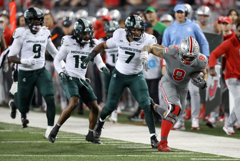 Nov 11, 2023; Columbus, Ohio, USA; Ohio State Buckeyes tight end Cade Stover (8) runs down the sidelines as Michigan State Spartans linebacker Aaron Brule (7),  defensive back Angelo Grose (15), and defensive lineman Zion Young (9) defend during the first quarter at Ohio Stadium. Mandatory Credit: Joseph Maiorana-USA TODAY Sports