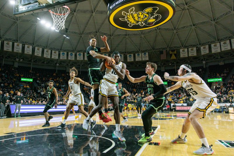 Jan 4, 2024; Wichita, Kansas, USA; North Texas Mean Green forward Aaron Scott (1) and Wichita State Shockers forward Dalen Ridgnal (10) go after a loose ball during the second half at Charles Koch Arena. Mandatory Credit: William Purnell-USA TODAY Sports