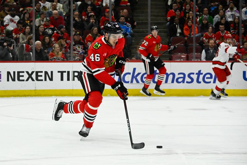 Jan 20, 2025; Chicago, Illinois, USA;   Chicago Blackhawks defenseman Louis Crevier (46) moves the puck against the Carolina Hurricanes during the first period at the United Center. Mandatory Credit: Matt Marton-Imagn Images


