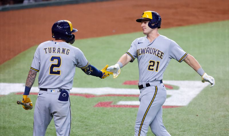 Aug 19, 2023; Arlington, Texas, USA;  Milwaukee Brewers left fielder Mark Canha (21) celebrates with Milwaukee Brewers second baseman Brice Turang (2) after scoring during the sixth inning against the Texas Rangers at Globe Life Field. Mandatory Credit: Kevin Jairaj-USA TODAY Sports