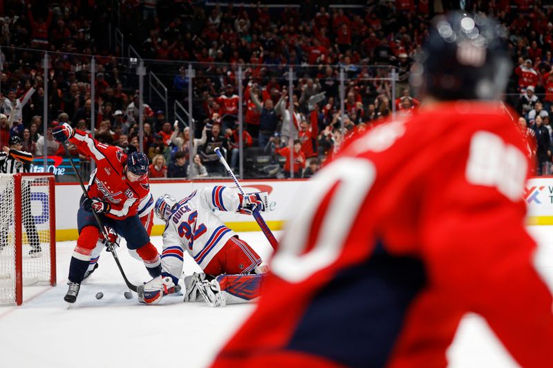 Jan 4, 2025; Washington, District of Columbia, USA; Washington Capitals center Aliaksei Protas (21) scores a goal on New York Rangers goaltender Jonathan Quick (32) in the third period at Capital One Arena. Mandatory Credit: Geoff Burke-Imagn Images