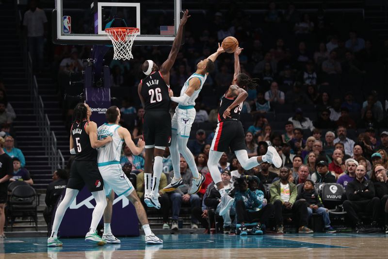 CHARLOTTE, NC - APRIL 3:  Jabari Walker #34 of the Portland Trail Blazers blocks the shot of Bryce McGowans #7 of the Charlotte Hornets on April 3, 2024 at Spectrum Center in Charlotte, North Carolina. NOTE TO USER: User expressly acknowledges and agrees that, by downloading and or using this photograph, User is consenting to the terms and conditions of the Getty Images License Agreement.  Mandatory Copyright Notice:  Copyright 2024 NBAE (Photo by Brock Williams-Smith/NBAE via Getty Images)