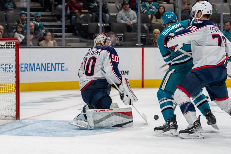 Nov 5, 2024; San Jose, California, USA;  Columbus Blue Jackets goaltender Elvis Merzlikins (90) makes a save against San Jose Sharks right wing Barclay Goodrow (23) during the second period at SAP Center at San Jose. Mandatory Credit: Neville E. Guard-Imagn Images