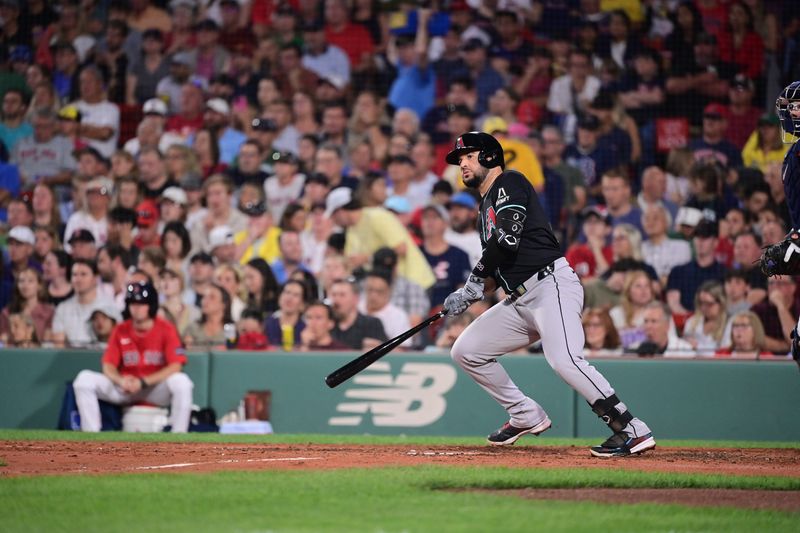 Aug 23, 2024; Boston, Massachusetts, USA; Arizona Diamondbacks third baseman Eugenio Suarez (28) drives in an RBI against the Boston Red Sox during the sixth inning at Fenway Park. Mandatory Credit: Eric Canha-USA TODAY Sports