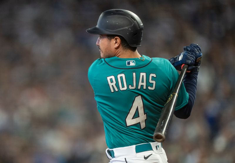 Sep 30, 2023; Seattle, Washington, USA; Seattle Mariners second baseman Josh Rojas (4) hits a single during the second inning against the Texas Rangers at T-Mobile Park. Mandatory Credit: Stephen Brashear-USA TODAY Sports