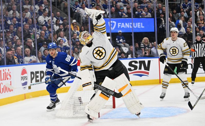 May 2, 2024; Toronto, Ontario, CAN;   Boston Bruins goalie Jeremy Swayman (1) reaches to catch the puck as defenseman Hampus Lindholm (27) and Toronto Maple Leafs forward William Nylander (88) look on in the first period in game six of the first round of the 2024 Stanley Cup Playoffs at Scotiabank Arena. Mandatory Credit: Dan Hamilton-USA TODAY Sports