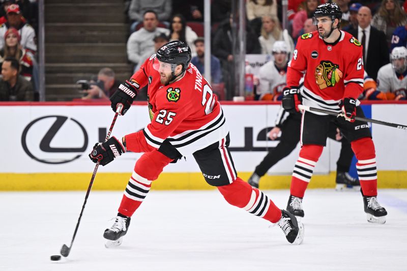 Jan 19, 2024; Chicago, Illinois, USA;  Chicago Blackhawks defensman Jarred Tinordi (25) attempts a shot on goal in the first period against the New York Islanders at United Center. Mandatory Credit: Jamie Sabau-USA TODAY Sports