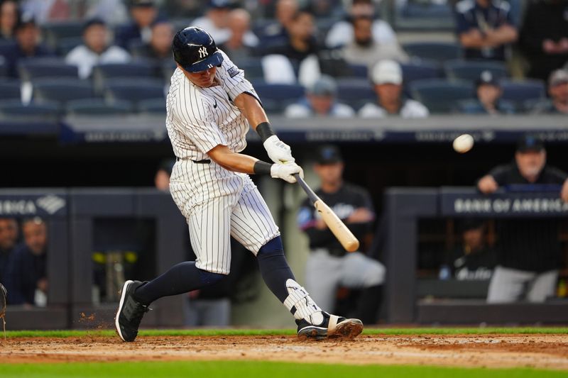 Apr 8, 2024; Bronx, New York, USA; New York Yankees shortstop Anthony Volpe (11) hits a three run home run against the Miami Marlins during the fourth inning at Yankee Stadium. Mandatory Credit: Gregory Fisher-USA TODAY Sports