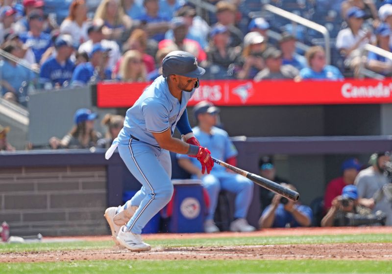 Aug 25, 2024; Toronto, Ontario, CAN; Toronto Blue Jays shortstop Leo Jiménez (49) hits a single against the Los Angeles Angels during the fourth inning at Rogers Centre. Mandatory Credit: Nick Turchiaro-USA TODAY Sports