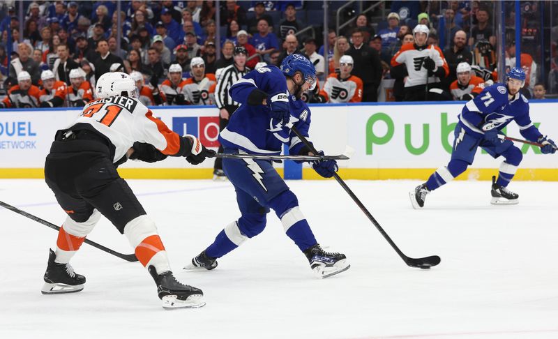 Nov 7, 2024; Tampa, Florida, USA; Tampa Bay Lightning right wing Nikita Kucherov (86) shoots as Philadelphia Flyers right wing Tyson Foerster (71) defends during the first period at Amalie Arena. Mandatory Credit: Kim Klement Neitzel-Imagn Images