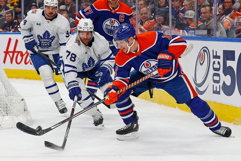 Jan 16, 2024; Edmonton, Alberta, CAN; Edmonton Oilers forward Zach Hyman (18) and Toronto Maple Leafs defensemen T.J. Brodie (78) battle for a loose puck during the first period at Rogers Place. Mandatory Credit: Perry Nelson-USA TODAY Sports