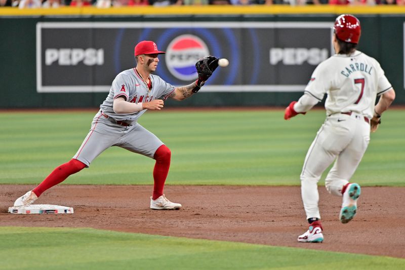 Jun 12, 2024; Phoenix, Arizona, USA; Los Angeles Angels shortstop Zach Neto (9) turns a double play on Arizona Diamondbacks outfielder Corbin Carroll (7) in the first inning at Chase Field. Mandatory Credit: Matt Kartozian-USA TODAY Sports