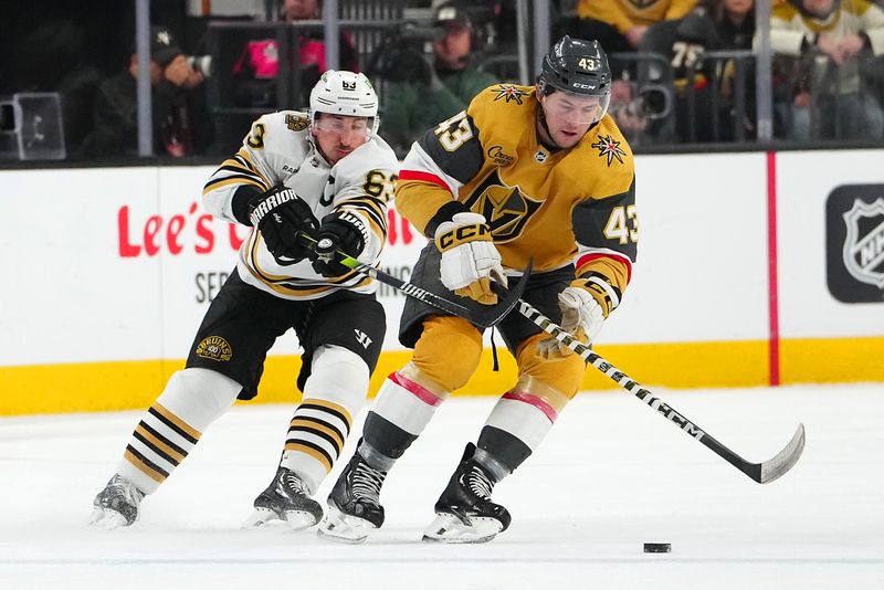 Jan 11, 2024; Las Vegas, Nevada, USA; Boston Bruins left wing Brad Marchand (63) stick checks Vegas Golden Knights center Paul Cotter (43) during the first period at T-Mobile Arena. Mandatory Credit: Stephen R. Sylvanie-USA TODAY Sports