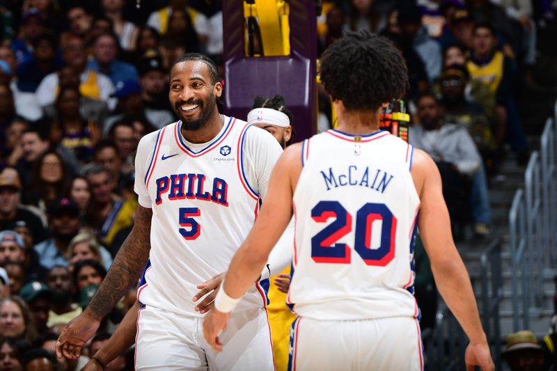 LOS ANGELES, CA - NOVEMBER 8: Andre Drummond #5 and Jared McCain #20 of the Philadelphia 76ers high five during the game against the Los Angeles Lakers on Novemberr 8, 2024 at Crypto.Com Arena in Los Angeles, California. NOTE TO USER: User expressly acknowledges and agrees that, by downloading and/or using this Photograph, user is consenting to the terms and conditions of the Getty Images License Agreement. Mandatory Copyright Notice: Copyright 2024 NBAE (Photo by Adam Pantozzi/NBAE via Getty Images)