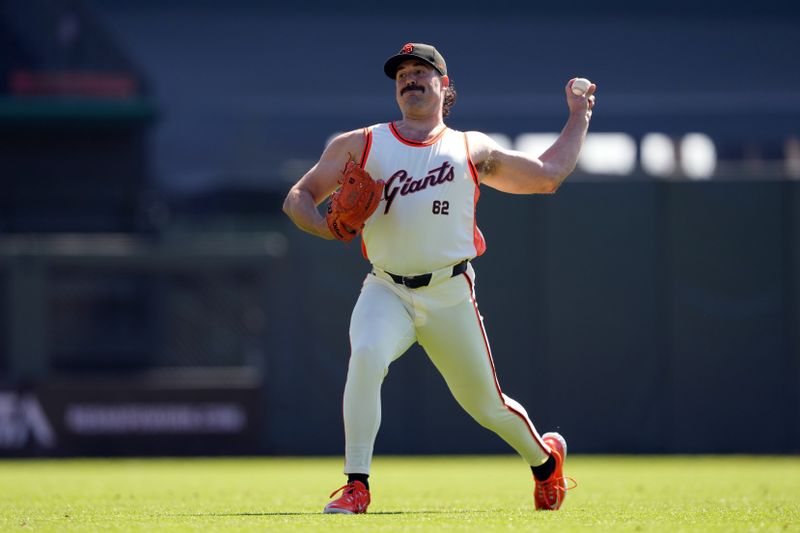 Sep 1, 2024; San Francisco, California, USA; San Francisco Giants starting pitcher Robbie Ray (23) warms up before the game against the Miami Marlins while wearing a basketball jersey of starting pitcher Logan Webb (62) at Oracle Park. Mandatory Credit: Darren Yamashita-USA TODAY Sports