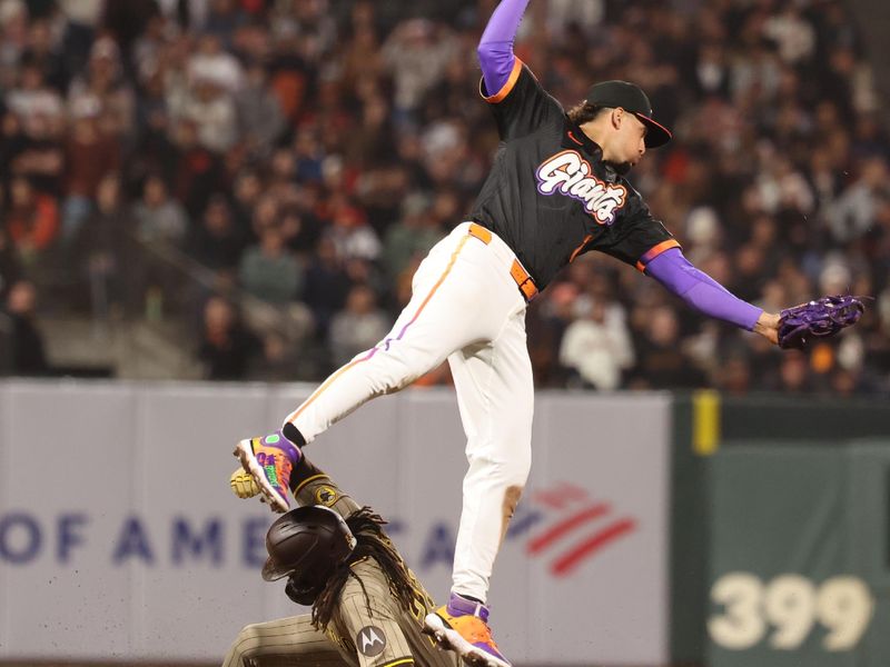 Jun 3, 2025; San Francisco, California, USA;  San Diego Padres right fielder Fernando Tatis Jr. (23) steals second base below San Francisco Giants shortstop Willy Adames (2) during the ninth inning at Oracle Park. Mandatory Credit: Kelley L Cox-Imagn Images