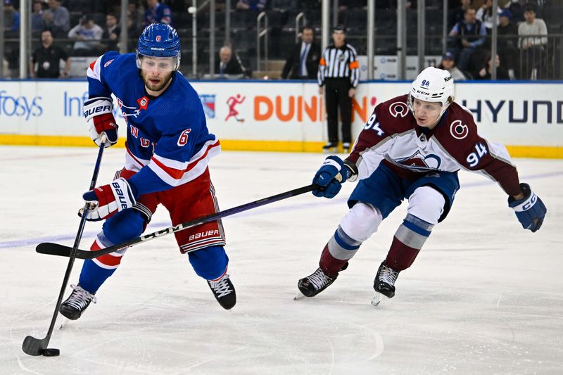 Feb 5, 2024; New York, New York, USA;  New York Rangers defenseman Zac Jones (6) skates with the puck defended by Colorado Avalanche left wing Joel Kiviranta (94) during the first period at Madison Square Garden. Mandatory Credit: Dennis Schneidler-USA TODAY Sports