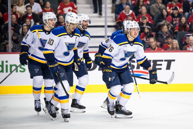 Dec 5, 2024; Calgary, Alberta, CAN; St. Louis Blues center Zachary Bolduc (76) celebrates with left wing Brandon Saad (20), center Brayden Schenn (10) and teammates after scoring a goal against the Calgary Flames during the first period at Scotiabank Saddledome. Mandatory Credit: Brett Holmes-Imagn Images