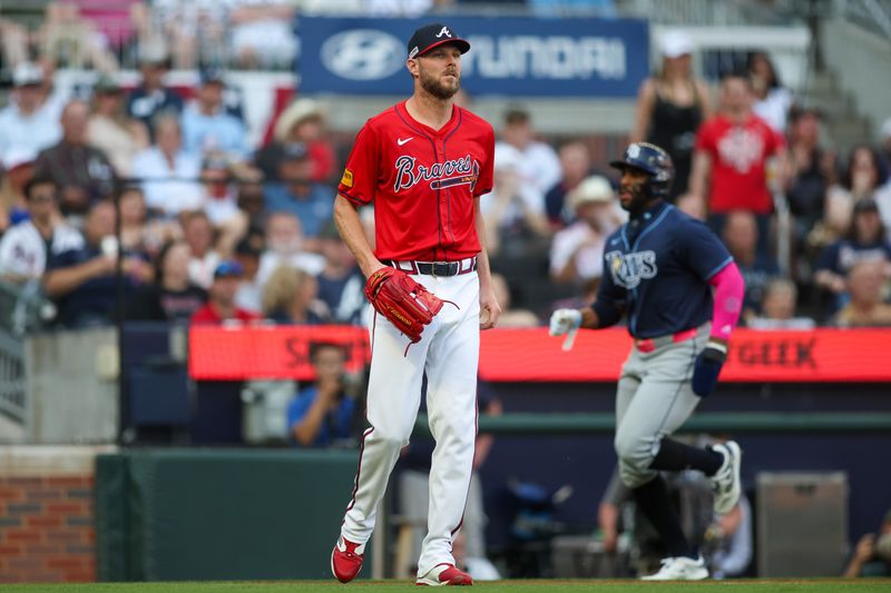 Jun 14, 2024; Atlanta, Georgia, USA; Atlanta Braves starting pitcher Chris Sale (51) reacts as Tampa Bay Rays first baseman Yandy Diaz (2) scores a run in the first inning at Truist Park. Mandatory Credit: Brett Davis-USA TODAY Sports
