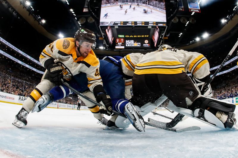 Mar 7, 2024; Boston, Massachusetts, USA; Boston Bruins defenseman Matt Grzelcyk (48) dumps Toronto Maple Leafs center Calle Jarnkrok (19) in the crease during the second period at TD Garden. Mandatory Credit: Winslow Townson-USA TODAY Sports