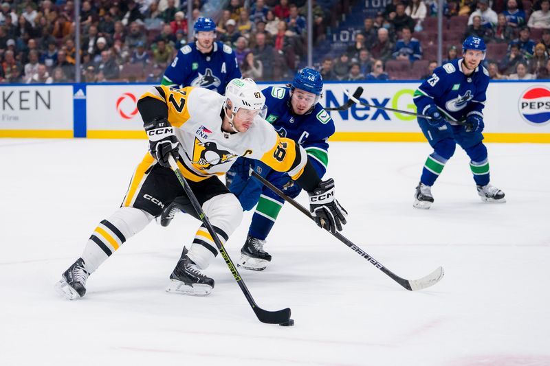 Feb 27, 2024; Vancouver, British Columbia, CAN; Pittsburgh Penguins forward Sidney Crosby (87) drives past Vancouver Canucks defenseman Quinn Hughes (43) in overtime at Rogers Arena. Penguins won 4-3 in overtime. Mandatory Credit: Bob Frid-USA TODAY Sports