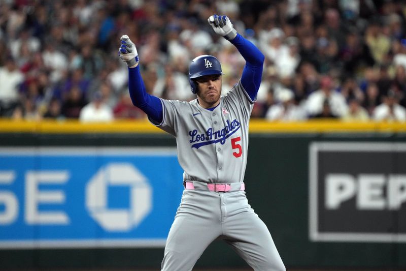 May 11, 2025; Phoenix, Arizona, USA; Los Angeles Dodgers first base Freddie Freeman (5) reacts after hitting a double against the Arizona Diamondbacks in the third inning at Chase Field. Mandatory Credit: Rick Scuteri-Imagn Images