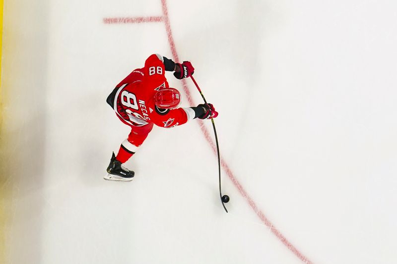 May 11, 2023; Raleigh, North Carolina, USA; Carolina Hurricanes center Martin Necas (88) shoots against the New Jersey Devils during the first period in game five of the second round of the 2023 Stanley Cup Playoffs at PNC Arena. Mandatory Credit: James Guillory-USA TODAY Sports