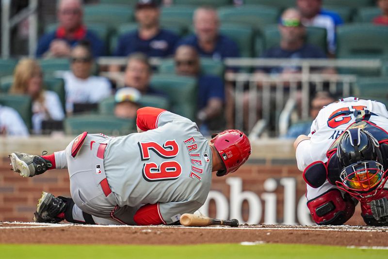 Sep 9, 2024; Cumberland, Georgia, USA; Cincinnati Reds center fielder TJ Friedl (29) and Atlanta Braves catcher Sean Murphy (12) are both injured after Friedl is hit by a pitch during the second inning at Truist Park. Mandatory Credit: Dale Zanine-Imagn Images