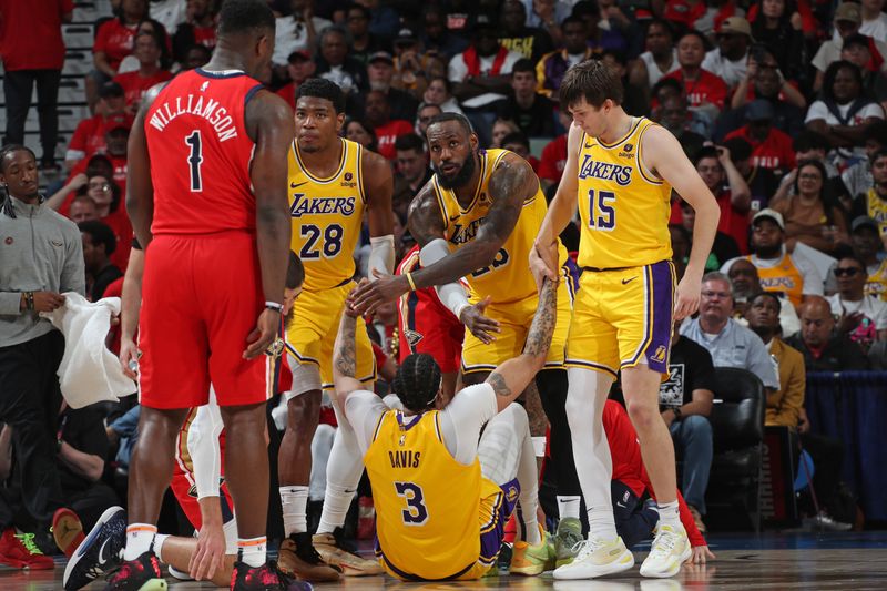 NEW ORLEANS, LA - APRIL 16: LeBron James #23 and Austin Reaves #15 of the Los Angeles Lakers help up Anthony Davis #3 during the game against the New Orleans Pelicans during the 2024 SoFi Play-In Tournament on April 16, 2024 at the Smoothie King Center in New Orleans, Louisiana. NOTE TO USER: User expressly acknowledges and agrees that, by downloading and or using this Photograph, user is consenting to the terms and conditions of the Getty Images License Agreement. Mandatory Copyright Notice: Copyright 2024 NBAE (Photo by Layne Murdoch Jr./NBAE via Getty Images)