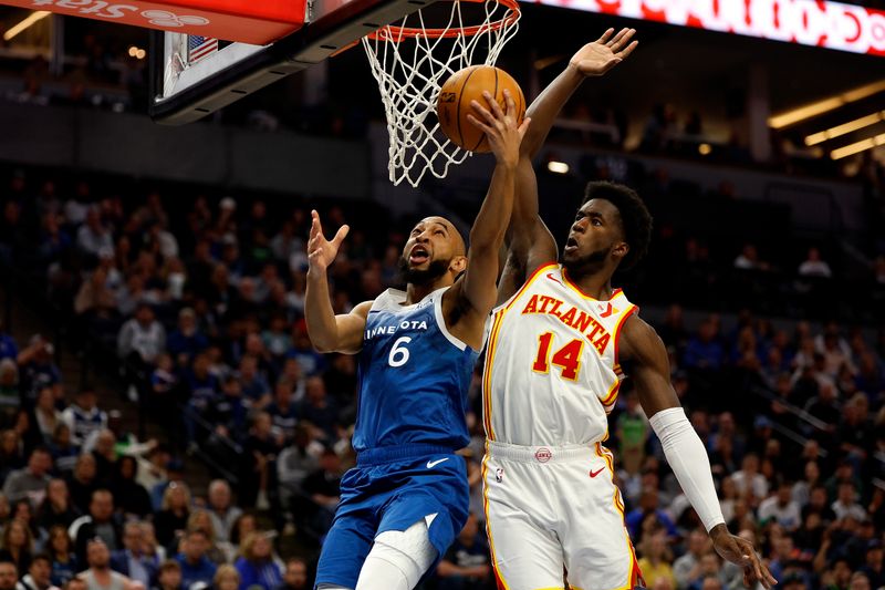 MINNEAPOLIS, MINNESOTA - APRIL 12: Jordan McLaughlin #6 of the Minnesota Timberwolves goes up for a shot against AJ Griffin #14 of the Atlanta Hawks in the fourth quarter at Target Center on April 12, 2024 in Minneapolis, Minnesota. The Timberwolves defeated the Hawks 109-106. NOTE TO USER: User expressly acknowledges and agrees that, by downloading and or using this photograph, User is consenting to the terms and conditions of the Getty Images License Agreement. (Photo by David Berding/Getty Images)