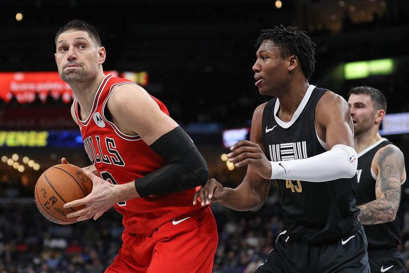 MEMPHIS, TENNESSEE - FEBRUARY 08: Nikola Vucevic #9 of the Chicago Bulls handles the ball against GG Jackson #45 of the Memphis Grizzlies during the first half at FedExForum on February 08, 2024 in Memphis, Tennessee. NOTE TO USER: User expressly acknowledges and agrees that, by downloading and or using this photograph, User is consenting to the terms and conditions of the Getty Images License Agreement. (Photo by Justin Ford/Getty Images)