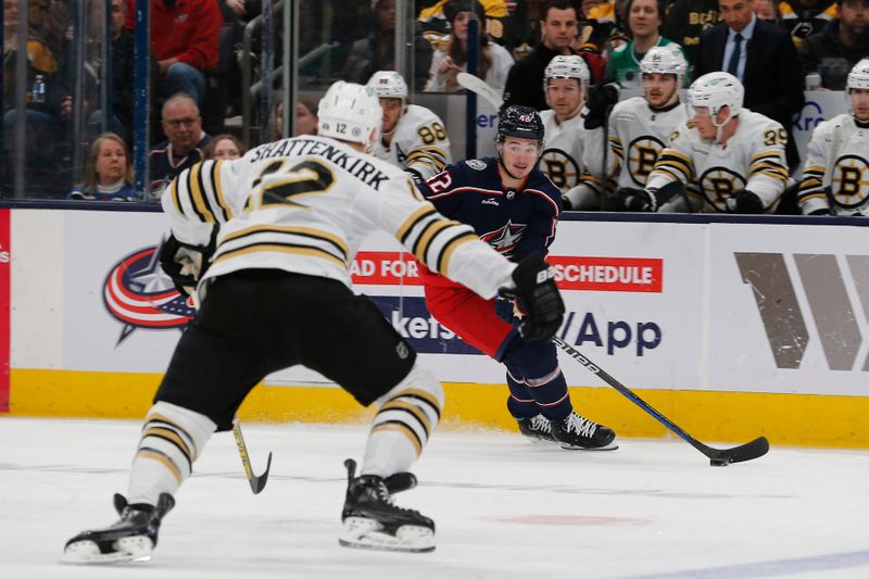 Jan 2, 2024; Columbus, Ohio, USA; Columbus Blue Jackets center Alexander Texier (42) looks to pass as Boston Bruins defenseman Kevin Shattenkirk (12) defends during the first period at Nationwide Arena. Mandatory Credit: Russell LaBounty-USA TODAY Sports