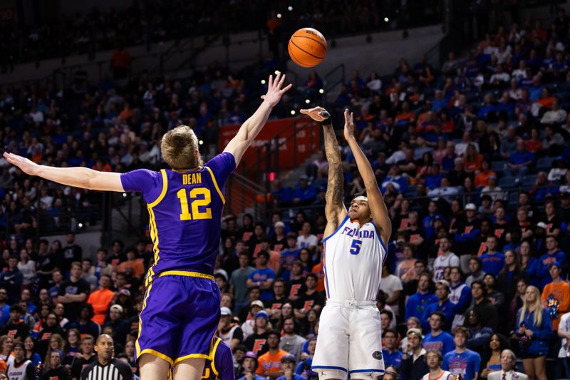 Feb 13, 2024; Gainesville, Florida, USA; Florida Gators guard Will Richard (5) shoots over LSU Tigers forward Hunter Dean (12) during the second half at Exactech Arena at the Stephen C. O'Connell Center. Mandatory Credit: Matt Pendleton-USA TODAY Sports