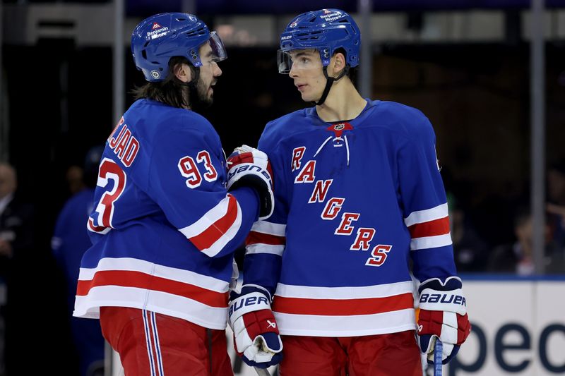 Mar 3, 2025; New York, New York, USA; New York Rangers center Mika Zibanejad (93) talks to defenseman Braden Schneider (4) during a time out during the second period against the New York Islanders at Madison Square Garden. Mandatory Credit: Brad Penner-Imagn Images