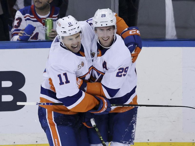 Nov 8, 2022; New York, New York, USA; New York Islanders left wing Zach Parise (11) and New York Islanders center Brock Nelson (29) embrace after defeating the New York Islanders at Madison Square Garden. Mandatory Credit: Jessica Alcheh-USA TODAY Sports