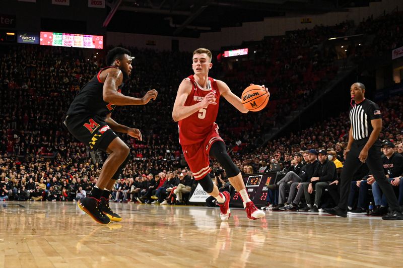 Jan 25, 2023; College Park, Maryland, USA;  Wisconsin Badgers forward Tyler Wahl (5) makes a move to the basket as Maryland Terrapins forward Donta Scott (24) defends during the first half at Xfinity Center. Mandatory Credit: Tommy Gilligan-USA TODAY Sports