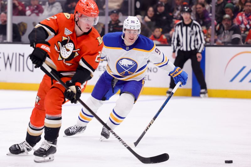 Nov 22, 2024; Anaheim, California, USA; Buffalo Sabres left wing Zach Benson (9) chases Anaheim Ducks defenseman Jackson LaCombe (2) during the second period at Honda Center. Mandatory Credit: Ryan Sun-Imagn Images