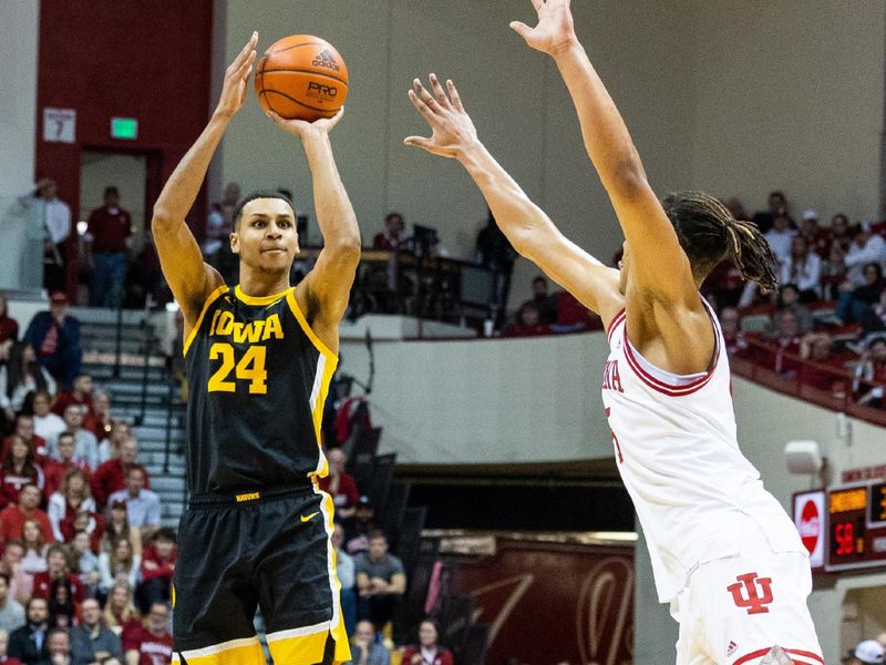 Feb 28, 2023; Bloomington, Indiana, USA; Iowa Hawkeyes forward Kris Murray (24) shoots the ball while Indiana Hoosiers forward Malik Reneau (5) defends in the second half at Simon Skjodt Assembly Hall. Mandatory Credit: Trevor Ruszkowski-USA TODAY Sports