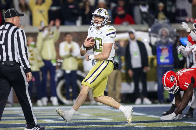 Nov 25, 2023; Atlanta, Georgia, USA; Georgia Tech Yellow Jackets quarterback Haynes King (10) runs for a touchdown against the Georgia Bulldogs in the second half at Bobby Dodd Stadium at Hyundai Field. Mandatory Credit: Brett Davis-USA TODAY Sports