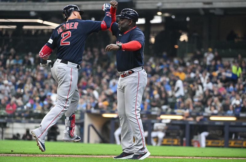 Apr 23, 2023; Milwaukee, Wisconsin, USA; Boston Red Sox first baseman Justin Turner (2) celebrates with Boston Red Sox third base coach Carlos Febles (53) after hitting a home run against the Milwaukee Brewers at American Family Field. Mandatory Credit: Michael McLoone-USA TODAY Sports