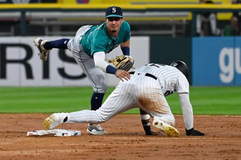 Aug 22, 2023; Chicago, Illinois, USA; Chicago White Sox right fielder Oscar Colas (22) is safe at second base as Seattle Mariners second baseman Josh Rojas (4) tries to throw for a double play during the second inning at Guaranteed Rate Field. Mandatory Credit: Matt Marton-USA TODAY Sports