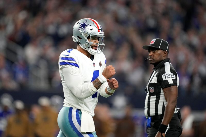 Dallas Cowboys quarterback Dak Prescott celebrates a touchdown during an NFL football game against the New York Giants as he walks past umpire Ramon George (128) in Arlington, Texas, Saturday, Nov. 12, 2023. (AP Photo/Tony Gutierrez)