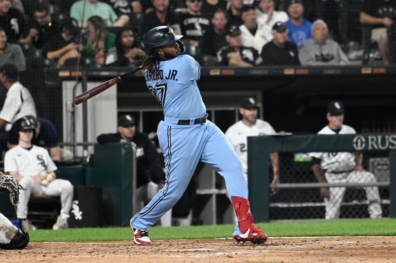 Jul 6, 2023; Chicago, Illinois, USA;  Toronto Blue Jays first baseman Vladimir Guerrero Jr. (27) hits an RBI single against the Chicago White Sox during the fifth inning at Guaranteed Rate Field. Mandatory Credit: Matt Marton-USA TODAY Sports