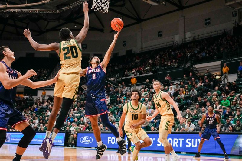 Jan 6, 2024; Charlotte, North Carolina, USA; Charlotte 49ers forward Robert Braswell IV (20) attempts to block a shot by Florida Atlantic Owls guard Nicholas Boyd (2) during the second half at Dale F. Halton Arena. Mandatory Credit: Jim Dedmon-USA TODAY Sports