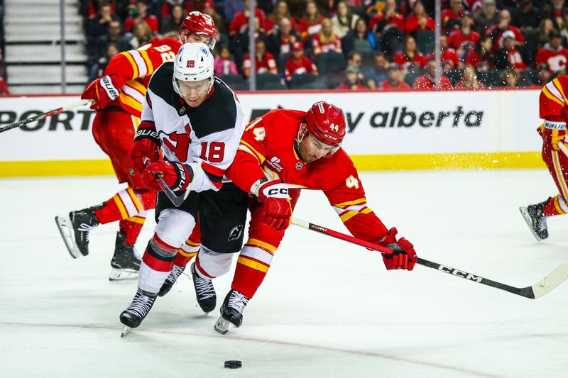Jan 19, 2026; Calgary, Alberta, CAN; Calgary Flames defenseman Joel Hanley (44) and New Jersey Devils left wing Ondrej Palat (18) battle for the puck during the second period at Scotiabank Saddledome. Mandatory Credit: Sergei Belski-Imagn Images