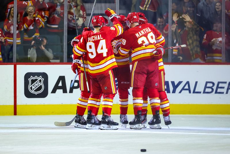 Oct 12, 2024; Calgary, Alberta, CAN; Calgary Flames center Jonathan Huberdeau (10) celebrates his goal with teammates against the Philadelphia Flyers during the third period at Scotiabank Saddledome. Mandatory Credit: Sergei Belski-Imagn Images