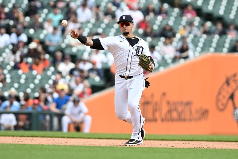 Apr 18, 2024; Detroit, Michigan, USA;  Detroit Tigers shortstop Javier Baez (28) throws to first base after fielding a groud ball against the Texas Rangers in the fourth inning at Comerica Park. Mandatory Credit: Lon Horwedel-USA TODAY Sports