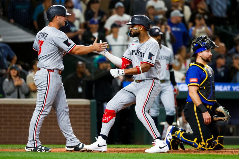 May 30, 2025; Seattle, Washington, USA; Minnesota Twins left fielder Willi Castro (50) celebrates with first baseman Ty France (13) after hitting a two-run home run against the Seattle Mariners during the ninth inning at T-Mobile Park. Mandatory Credit: Joe Nicholson-Imagn Images