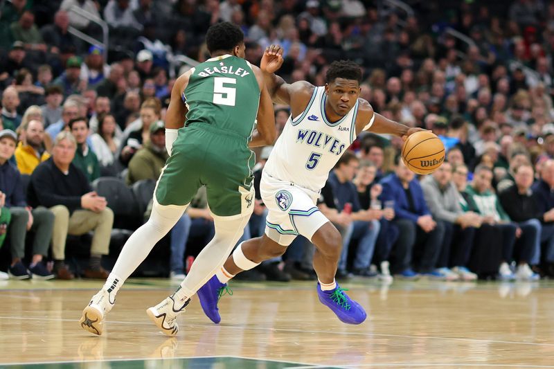 MILWAUKEE, WISCONSIN - FEBRUARY 08: Anthony Edwards #5 of the Minnesota Timberwolves drives around Malik Beasley #5 of the Milwaukee Bucks during a game at Fiserv Forum on February 08, 2024 in Milwaukee, Wisconsin. NOTE TO USER: User expressly acknowledges and agrees that, by downloading and or using this photograph, User is consenting to the terms and conditions of the Getty Images License Agreement. (Photo by Stacy Revere/Getty Images)